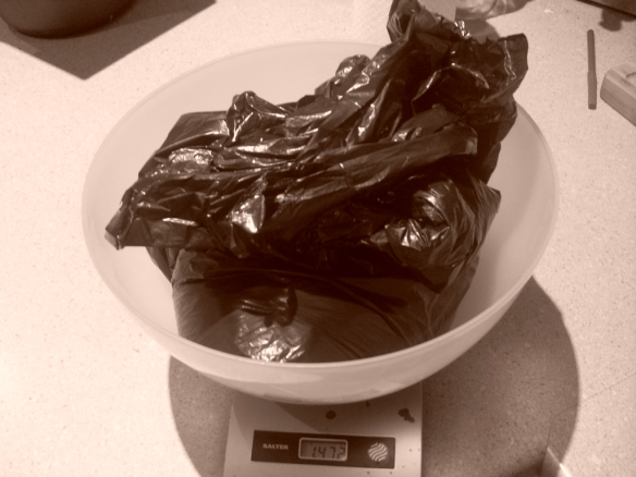 weighing used coffee grounds before drying
